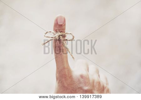 String tired around finger, selective focus, soft focus vintage tone