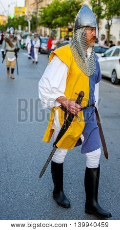 Modugno Italy - June 23 2016: parade with costumes of the Middle Ages. Featured soldier with helmet in metal and armed with sword