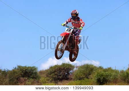 Wingate, Israel - July 23, 2016: Motocross rider and bike clearing a tabletop jump during the final heat of the race.