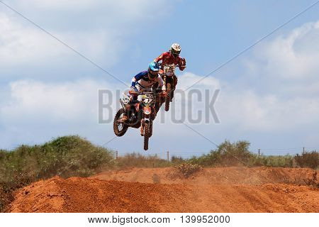 Wingate, Israel - July 23, 2016: Motocross rider and bike clearing a tabletop jump during the final heat of the race.