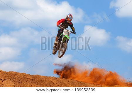 Wingate, Israel - July 23, 2016: Motocross rider and bike clearing a tabletop jump during the final heat of the race.