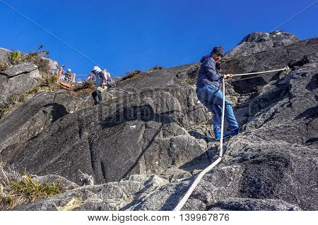 Ranau,Sabah, Borneo-March 13,2016: Group of climbers move down from Low's Peak to Laban Rata at Mountain Kinabalu on 13th March 2016.There are two summit trails,Ranau Trail & Kota Belud Trail.