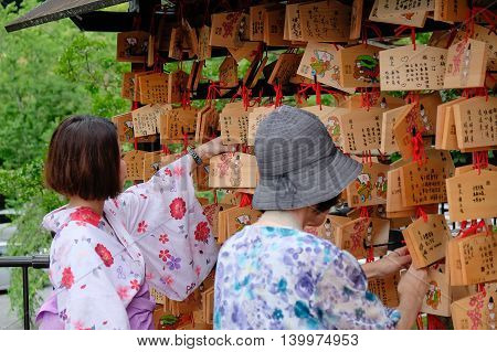 KYOTO JAPAN JUL 9 2016: Tourists walk on a street around Kiyomizu. Kiyomizu is a famous temple in Kyoto built in year 778. That is part of the Historic Monuments of Ancient Kyoto