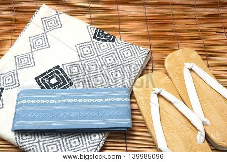 Japanese yukata and a band for men on bamboo blinds. Concept of Japanese summer.