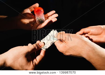 Closeup of drug dealer taking money for cocaine