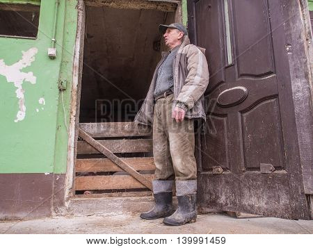 Bobrek Poland - February 10 2016: A polish farmer standing in front of a pigstay