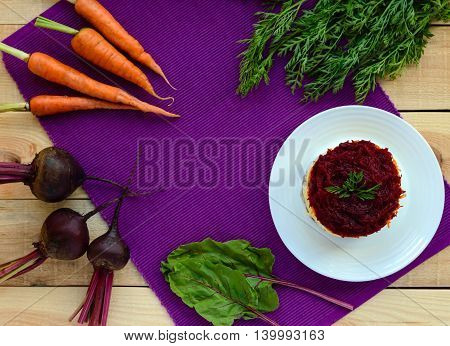 Salad with layers of cooked vegetables and salted fish (