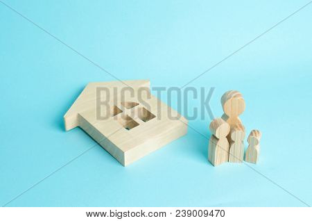 The Family Stands Near The Ruined Fallen House. Loss Of Housing, Home Insurance. Accident, Natural D