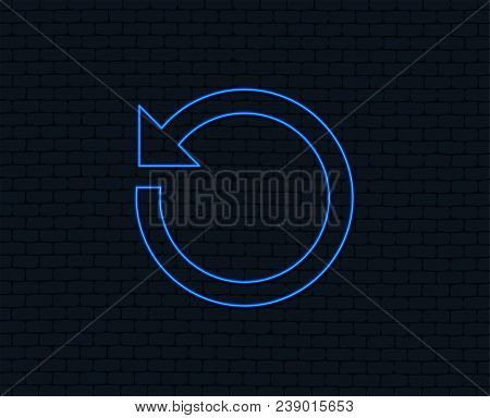Neon Light. Repeat Icon. Refresh Symbol. Loop Sign. Glowing Graphic Design. Brick Wall. Vector
