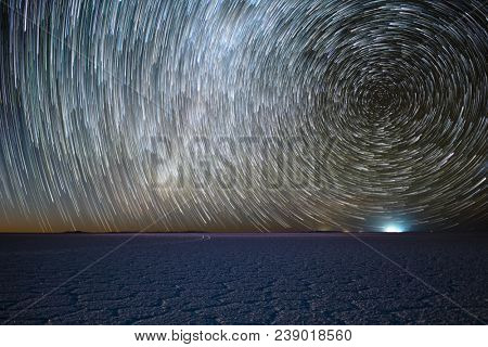Salar de Uyuni salt flat under night starry sky with star trails like a comets. Altiplano, Bolivia