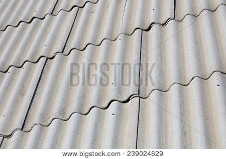 A Fragment Of A Gray Slate Roof Of An Old Sample Made Of Asbestos Material