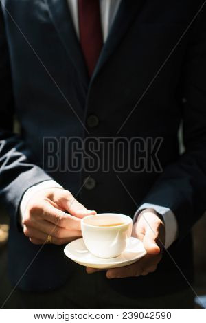 Businessman holding coffee cup