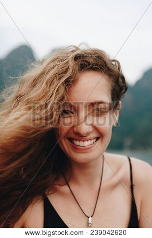 Portrait of a beautiful woman with curly hair