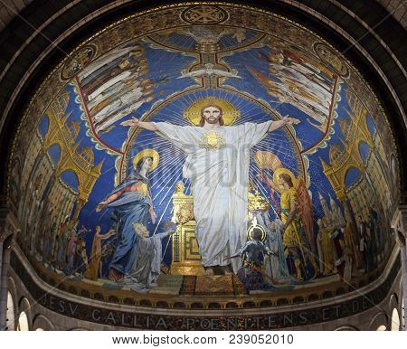 PARIS, FRANCE - JANUARY 08, 2018: Christ in Majesty is surrounded by the Virgin Mary, Joan of Arc and St. Michael, mosaic by Luc-Olivier Merson, Basilica of the Sacred Heart of Jesus in Paris.
