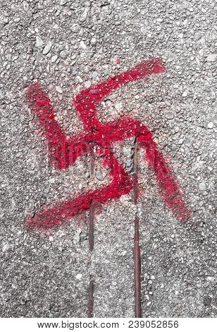 Sign On Road Floor Of The Svastika Symbol.