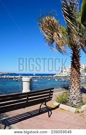 San Pawl, Malta - April 2, 2017 - Wrought Iron Railings Along The Promenade With Views Of The Harbou