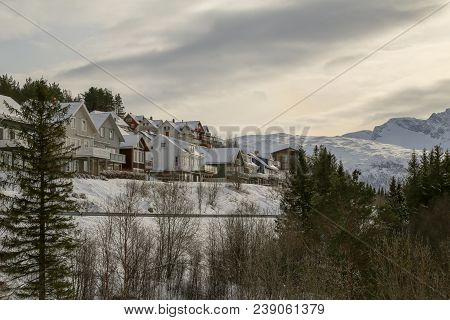 Norway, Houses At The Mountain Slope Above Narvik City On A Winter Day With Lots Of Snow