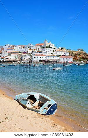 Ferragudo, Portugal - June 10, 2017 - View Of The White Town With Boats Moored On The River Arade, F