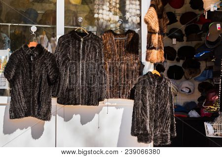 Fur Coats Sell Outdoors In The City Park, Goryachy Klyuch, Russia. Copy Space For Text