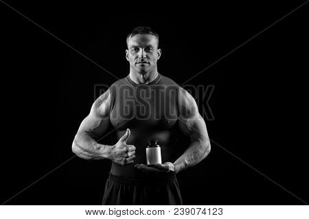 Nutrition Supplements For Bodybuilder. Sportsman With Vitamin Bottle Show Thumbs Up. Food And Diet F