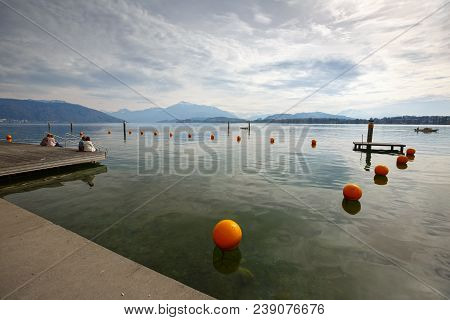 Embankment Of The Lake Zug, German - Zugersee. View Of The Alps Mountains. Town Of Cham, Canton Of Z
