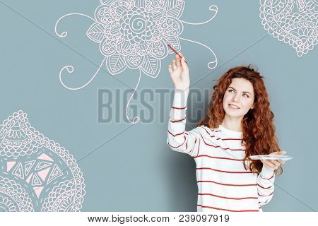 Pleasant Activity. Talented Young Painter Feeling Happy While Working At The New Picture
