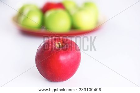 Red Apple Lies On A White Table.