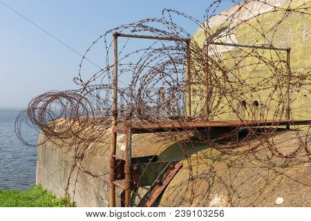 Ww2 Concrete Shelter With Barbed Wire Near Kornwerderzand At Dutch Afsluitdijk