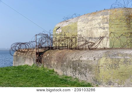 Ww2 Concrete Shelter With Barbed Wire Near Kornwerderzand At Dutch Afsluitdijk