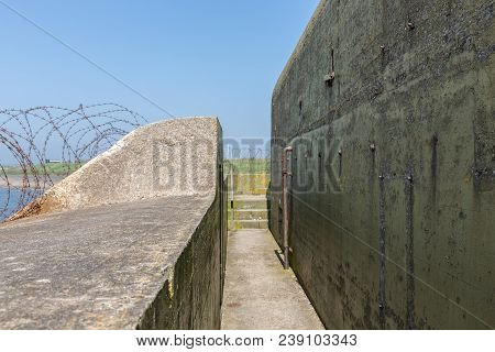 Ww2 Concrete Shelter With Barbed Wire Near Kornwerderzand At Dutch Afsluitdijk