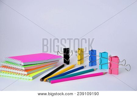 Colorful Notepads Clip For Paper And Pencils On A White Background In The Correct Geometry
