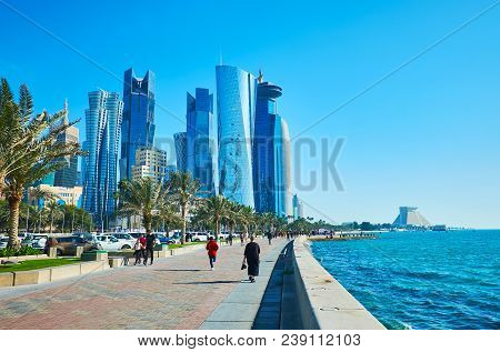 Doha, Qatar - February 13, 2018: The Corniche Promenade Stretches Along The Glass Skyscrapers Of Al 