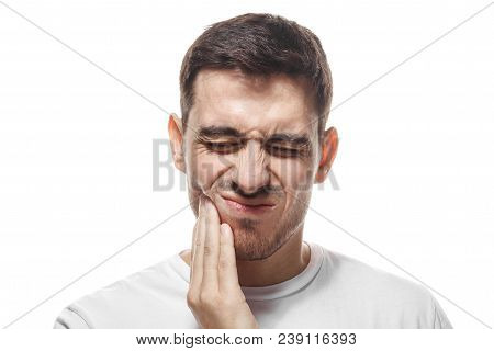 Indoor Portrait Of Young Handsome Caucasian Guy Pictured Isolated On White Background, His Face Dist