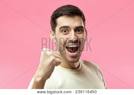 Horizontal Portrait Of Young Caucasian Guy Pictured Isolated On Pink Background Wearing Casual T-shi