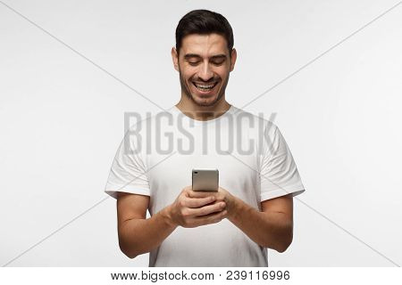 Indoor Picture Of Handsome Caucasian Man Isolated On Gray Background Wearing White Casual T-shirt La