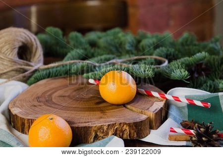 Tangerines Mandarins With Christmas Tree Branches With Spices, Candy Sticks On Wooden Board Fell Asl