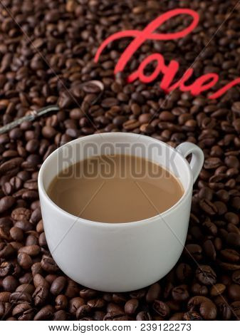 Cup Of Coffee With Milk On Background Of Coffee Beans