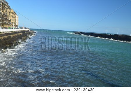 Wonderful Views Of The San Sebastian Bay From Its Promenade And Strong Waves Loading Against Your Br