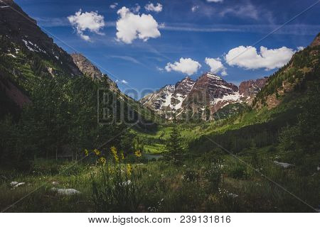 Majestic Maroon Bells Peaks And Maroon Lake On A Sunny Day And Blue Sky In Summer Near Aspen, Colora