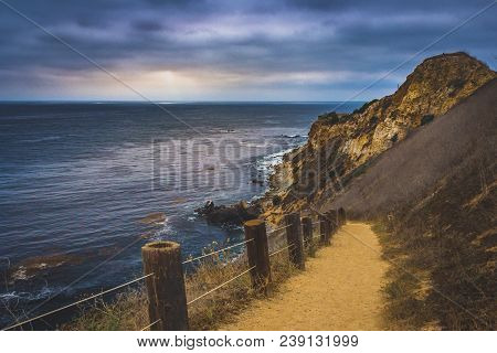 Coastal Hiking Trail Cascading Down The Steep Cliffs Of Pelican Cove Park On A Cloudy Day With Beams