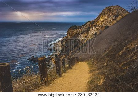 Coastal Hiking Trail Cascading Down The Steep Cliffs Of Pelican Cove Park On A Cloudy Day With Beams