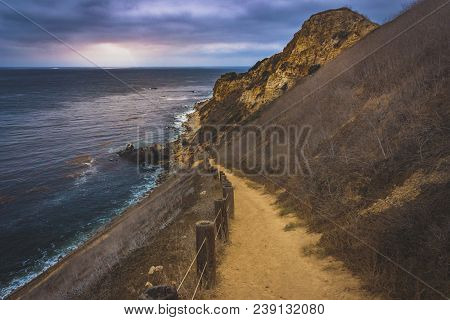 Coastal Hiking Trail Cascading Down The Steep Cliffs Of Pelican Cove Park On A Cloudy Day With Beams
