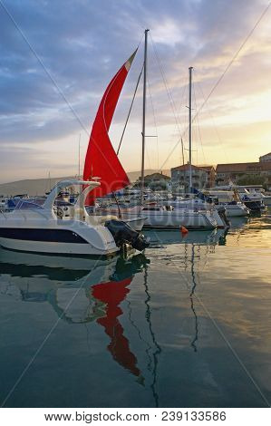 Boat With Red Sail In Harbor. Montenegro, Marina Kalimanj In Tivat City