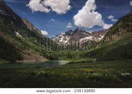 Majestic Maroon Bells Peaks And Maroon Lake On A Sunny Day And Blue Sky In Summer Near Aspen, Colora