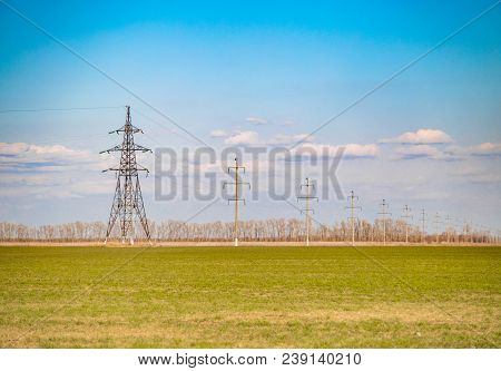 Electrification Of The Country Green Grass Field With Tree Lines