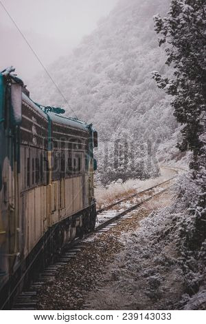 Train Passenger Perspective Of The Winding Verde Canyon Railroad With Snow Covering The Trees And Ro