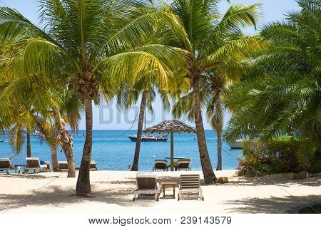 Antigua, Caribbean Islands - May 20, 2017: English Harbour View With Galeon Beach, Sun Beds And Umbr