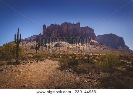 Iconic View Of Superstition Mountains And Saguaro Cacti In Lost Dutchman State Park, Arizona From Tr