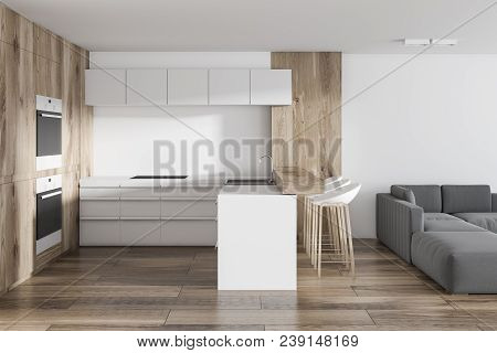 Studio Apartment Kitchen And Living Room With A Wooden Bar And Built In Apliances. Concept Of A Comf