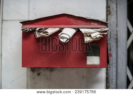 An overfull old post box